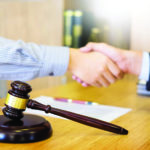 Gavel Justice hammer on wooden table with judge and client shaki