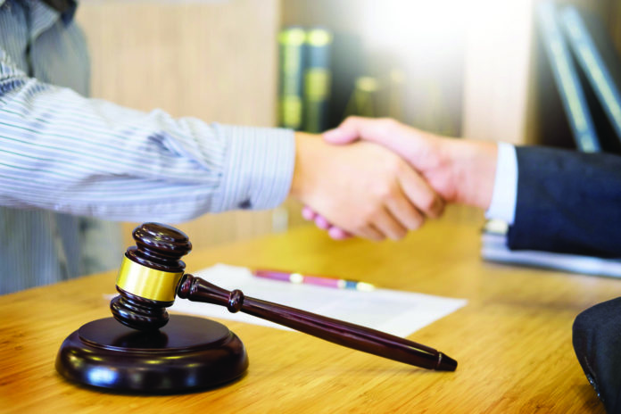 Gavel Justice hammer on wooden table with judge and client shaki