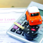 Car loan application with car keys and model car