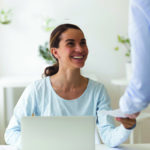 Smiling biracial manager satisfied with cash bonus reward.
