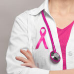 Female doctor with pink ribbon. Cancer concept
