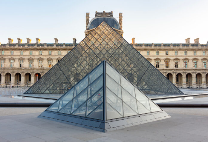 Louvre palace and pyramid in center of Parism France