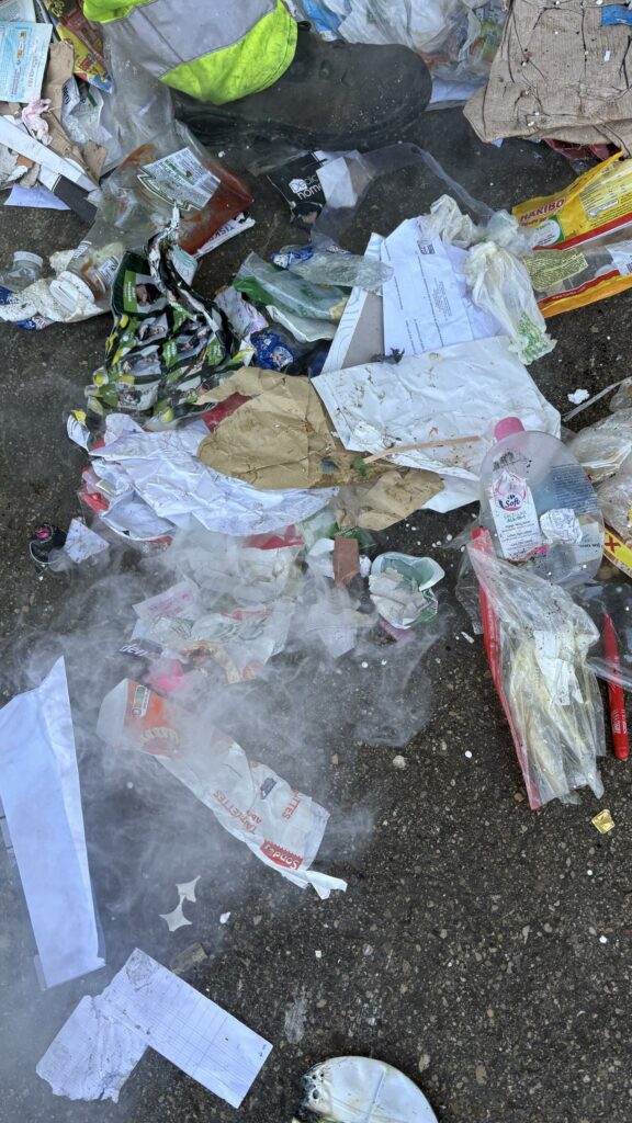Déchets divers avec de la fumée, potentiellement due à des départs de feu de batteries lithium.