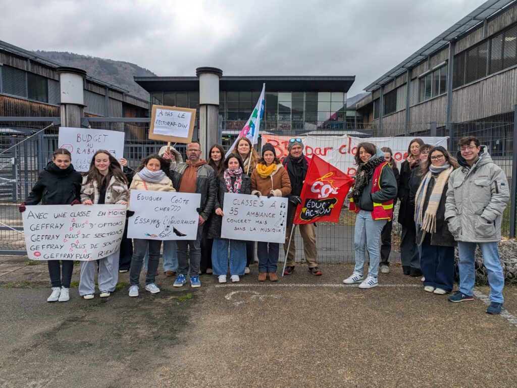 Manifestation pour le maintien de la classe de seconde à Nantua avec des pancartes et un drapeau syndical.