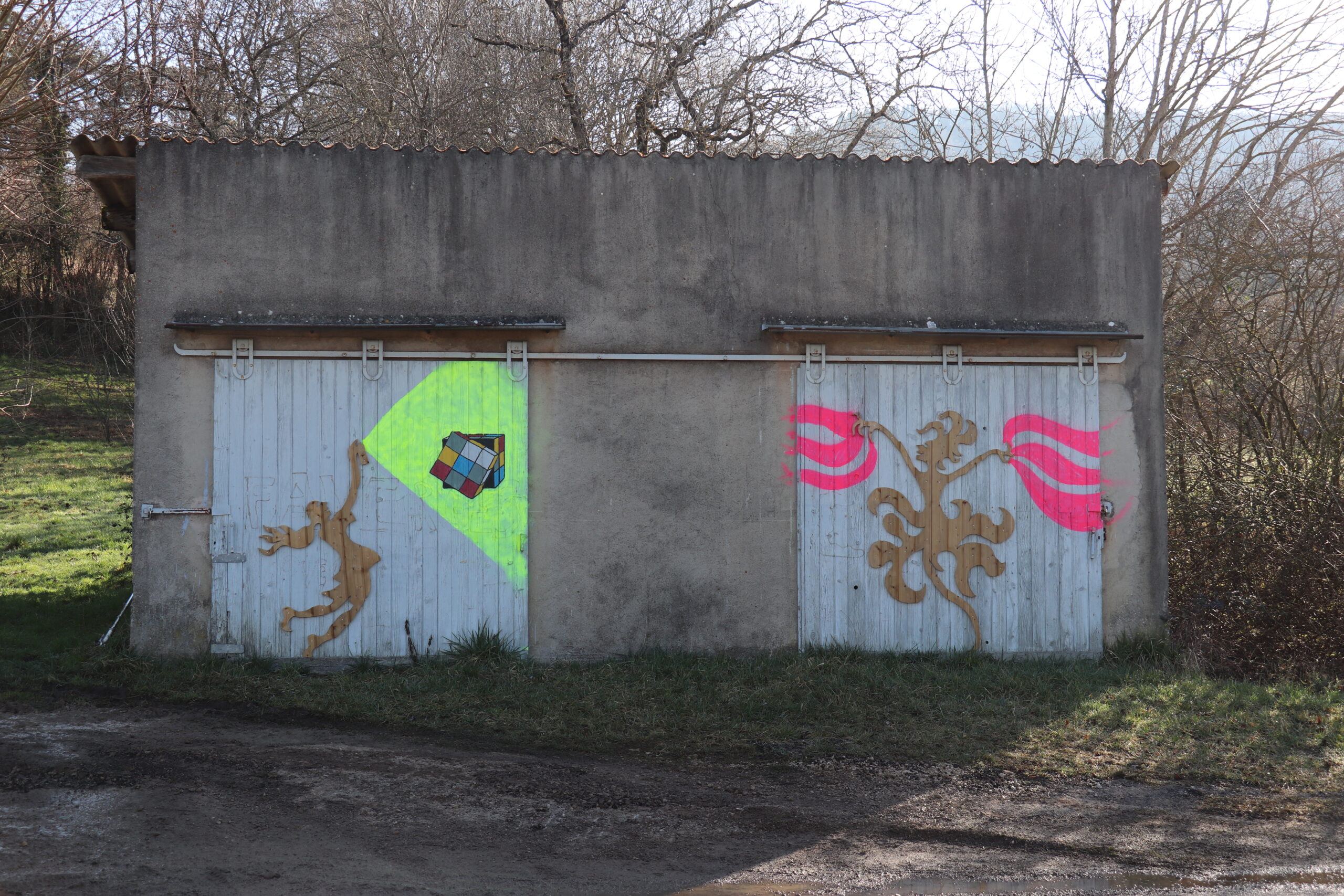 Portes d’un garage sur la route de Faverges avec dessins artistiques.