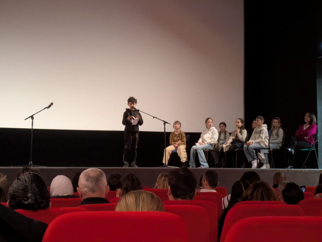 Un enfant lit sur scène lors de la finale départementale petits champions.