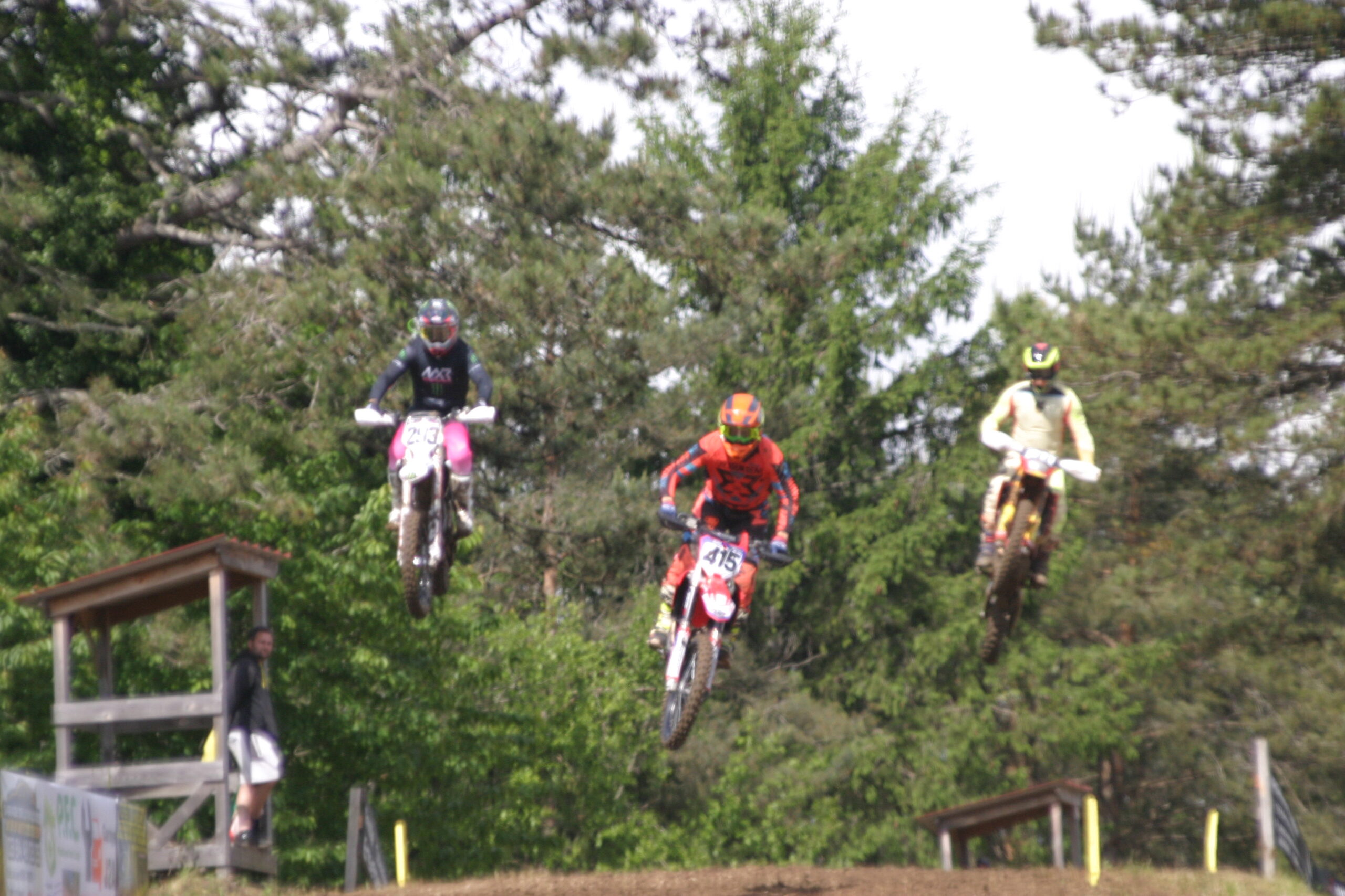 Moto de cross en plein saut sur la piste