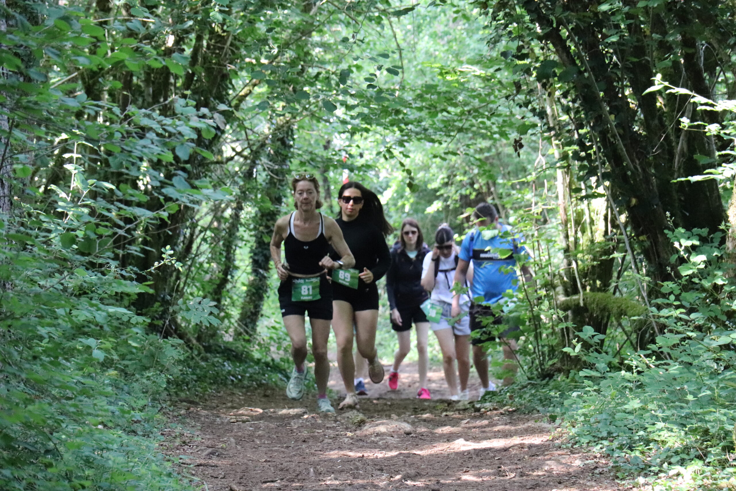 Coureurs en plein effort sur chemin forestier jurassien à l'Adventur’Games 2026 Maisod