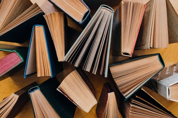 Group of books on wooden planks background